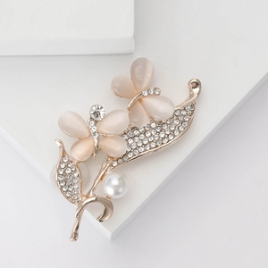 Elegant gold butterfly brooch with pink opal stones, sparkling rhinestones and a white pearl