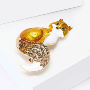 Detailed view of fox brooch with gradient crystals and warm orange enamel inlay