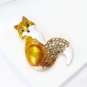Detail of fox brooch with yellow enamel, sparkling rhinestones and green gemstone eye