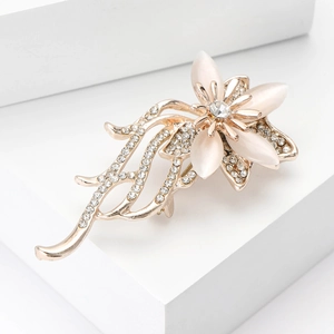 Elegant rose gold flower brooch with cat eye stones and sparkling crystals for suits