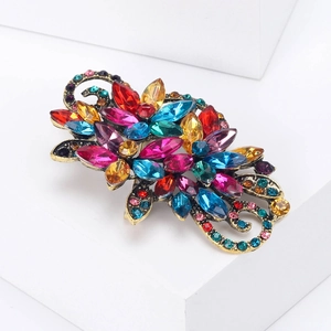 Close-up of vintage flower brooch with colorful crystals on a geometric display