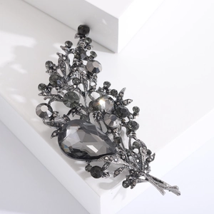 Detailed macro view of retro bouquet brooch with smoky grey crystals and pear-shaped stone