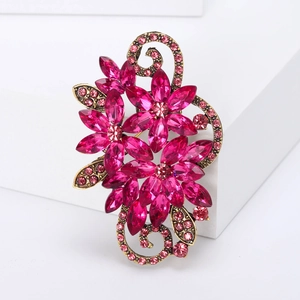 Detailed macro view of vintage flower brooch with pink crystals and antique gold finish