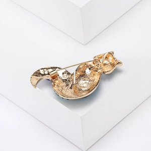 Detailed back view of golden fox brooch showing the sturdy pin and textured alloy finish