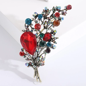 Vintage floral bouquet brooch with colorful crystals and bronze finish on white background