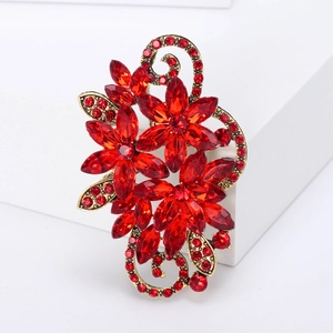 Detailed view of vintage gold flower brooch featuring vibrant red marquis crystals and rhinestones