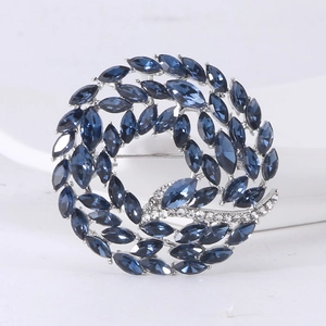 Detailed close-up of dark blue marquise-cut crystal brooch with sparkling rhinestone accents