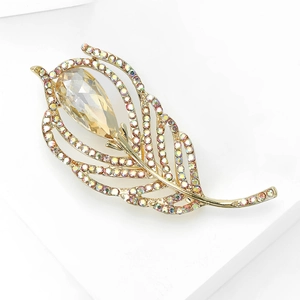 Detail of elegant feather brooch with crystal pave and champagne teardrop stone