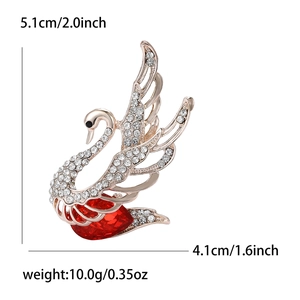 Elegant rose gold swan brooch with white rhinestones and a large red heart gemstone