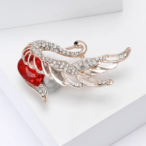 Elegant rose gold swan brooch with sparkling white rhinestones and a red heart gemstone