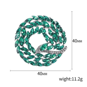 Elegant 40mm crystal circle brooch with green gems and diamonds for women's fashion