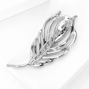 Macro view showing the sturdy silver pin clasp mechanism on the back of the feather brooch