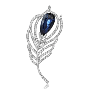 Elegant feather brooch with white diamonds and a large teardrop blue gemstone