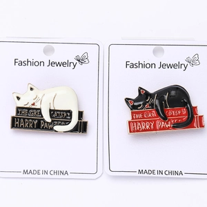 Detailed enamel cat pins with literary parodies on white fashion jewelry card