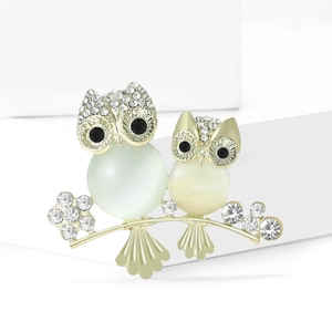 Elegant cat eye stone owl brooch with sparkling rhinestones on a clean white background