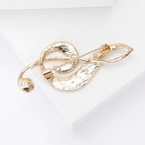 Elegant gold treble clef music brooch with textured finish and secure pin closure