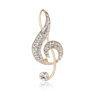 Elegant gold G-clef musical note brooch with sparkling crystals on a white background