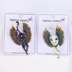 Detailed close-up of winged cat brooches with ornate Egyptian style colorful enamel plating