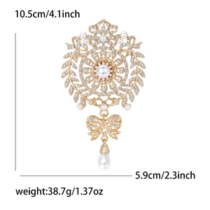 Elegant gold vintage brooch with pearls, crystals, and bow pendant for women's fashion
