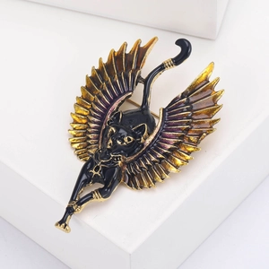 Detailed view of Egyptian Bastet cat brooch with golden wings and black enamel finish