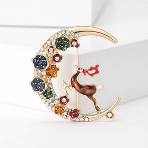 Detailed macro view of moon-shaped reindeer brooch with colorful enamel rose flowers