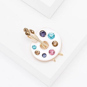 Artistic painter palette brooch with white enamel, colorful rhinestones, and gold brushes