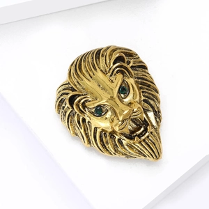 Vintage golden lion head brooch for men with sparkling green eyes and detailed mane texture