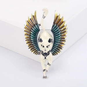 Close-up detail of Egyptian winged cat brooch with cream enamel and gradient wings