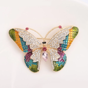 Macro detail of butterfly brooch with colorful enamel wings and sparkling crystals