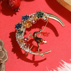 Christmas crescent moon brooch with reindeer and colorful floral rhinestones on red background