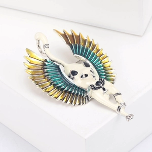Detailed close-up of an Egyptian style winged cat brooch with colorful enamel finish