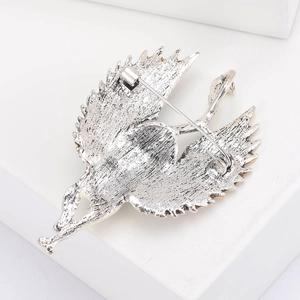 Detailed back view of silver swan brooch showing the secure safety pin fastening mechanism