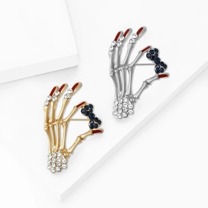 Minimalist alloy skull hand brooches with rhinestone bowties in gold and silver finish