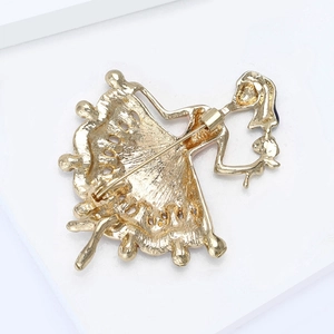 Back view of gold enamel ballet dancer brooch showing secure pin clasp and metal finish