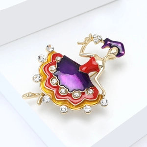 Detailed close-up of a golden ballerina brooch with colorful enamel and sparkling rhinestones