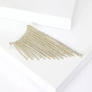 Detail showing high-shine silver tassels with sparkling rhinestones on a white cube