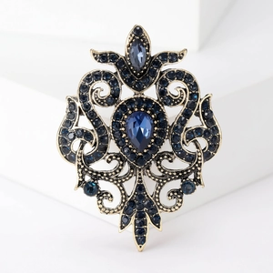 Vintage baroque alloy brooch with blue waterdrop gemstone and intricate filigree design
