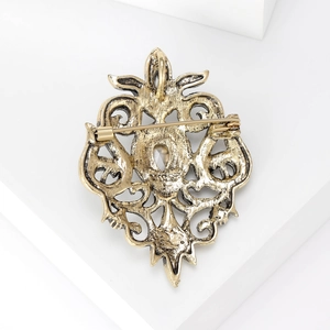 Vintage Baroque hollow alloy brooch with rhinestones and antique gold finish back view