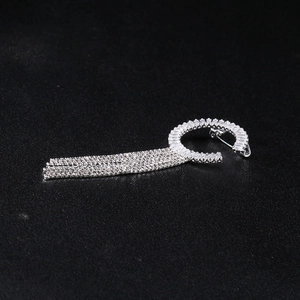 Vue détaillée d'une broche argentée à pampilles avec cercle de strass et franges en métal