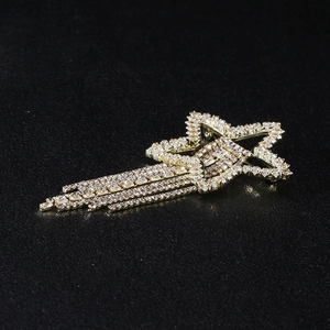 Macro view of gold pentagram brooch with rhinestone tassels and star-shaped crystal details