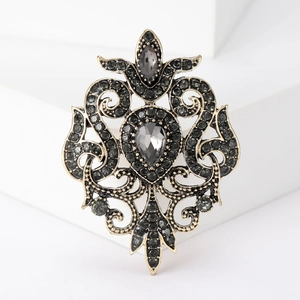 Detail view of Baroque alloy brooch with grey rhinestones and antique gold finish