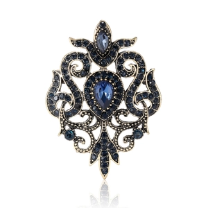 Vintage baroque alloy brooch with blue rhinestones and large pear-shaped blue gemstone