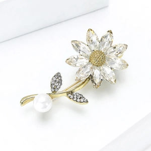 Elegant daisy brooch with crystals, golden petals and a large white pearl accent