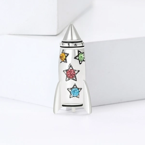 Polished S925 silver rocket charm with colorful star zircons on minimalist background