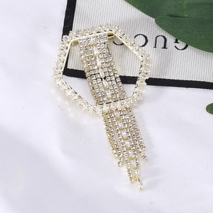 Exaggerated geometric hexagonal brooch with long rhinestone tassels in gold-tone metal