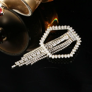 Elegant geometric hexagonal brooch with sparkling rhinestone tassels on black background