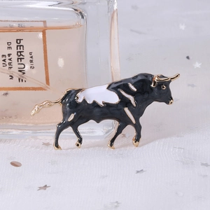 Exquisite ox zodiac brooch with black and white enamel in a gold metallic setting