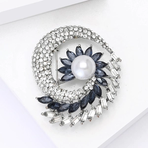 Exquisite floral brooch with large pearl, blue rhinestones and silver swirling frame