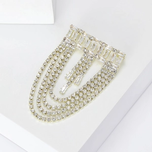 Detail of silver layered fringe brooch with sparkling rhinestones and crystal chains