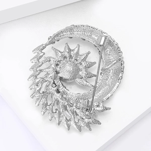 Detailed back view of silver crescent moon and sun brooch with secure safety pin clasp